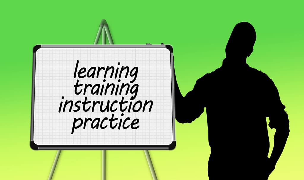 A graphic showing someone at a flip chart with the words learning, training, instruction, and practice